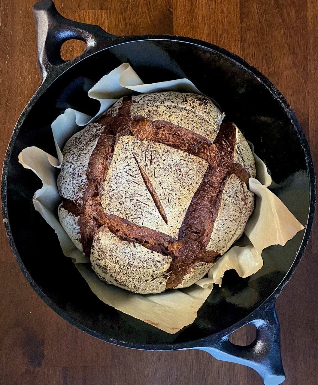 Loaf of Black Death bread in a black cast iron skillet 